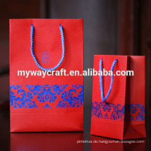 Chinesisches Muster geprägtes rotes Hochzeitsgeschenkpapierbeutel